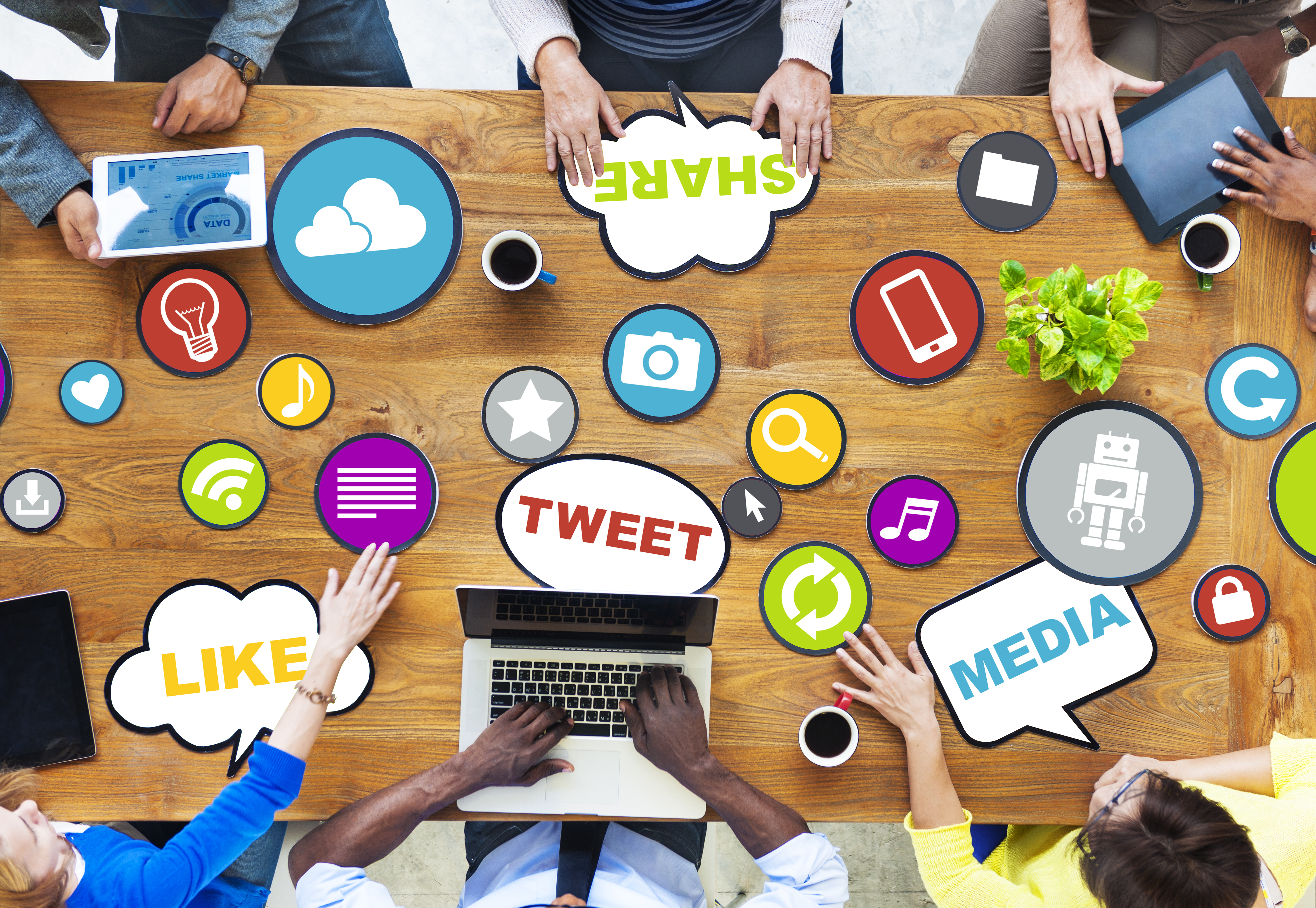 Person at desk with various social media names in bubbles